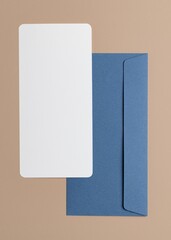 Blank white card, blue envelope, flat lay design