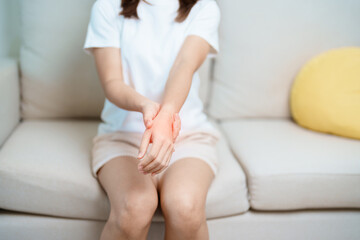 Woman having wrist pain at home, muscle ache due to De Quervain s tenosynovitis, ergonomic, Carpal Tunnel Syndrome or Office syndrome and Parkinson disease concept