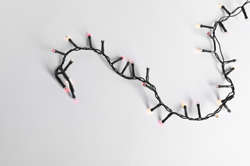 Beautiful Christmas lights on white background, top view