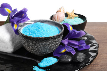 Light blue sea salt in bowls, flowers, starfish, seashell and towel on wooden table against white...