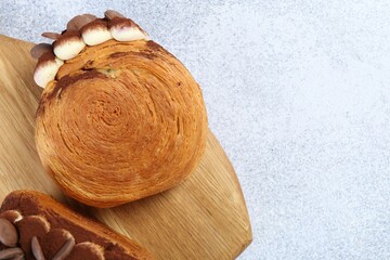 Tasty puff pastry. Supreme croissants with chocolate chips and cream on grey table, top view. Space...
