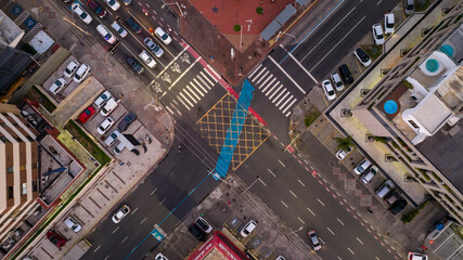 Digital billboard lighting up in intersection with cars and pedestrian crossings