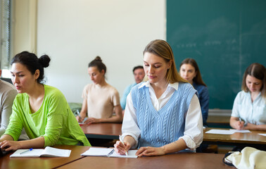 Portrait of an adult positive female student during class in the university auditorium
