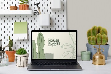 Laptop screen with online plant shop website, aesthetic workspace
