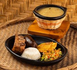 Traditional Colombian gastronomy - Wheat cuchuco - Roast peasant boyacense baked pork rib and blood...