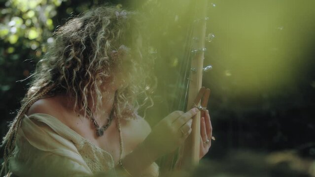 Woman playing sitar in the forest