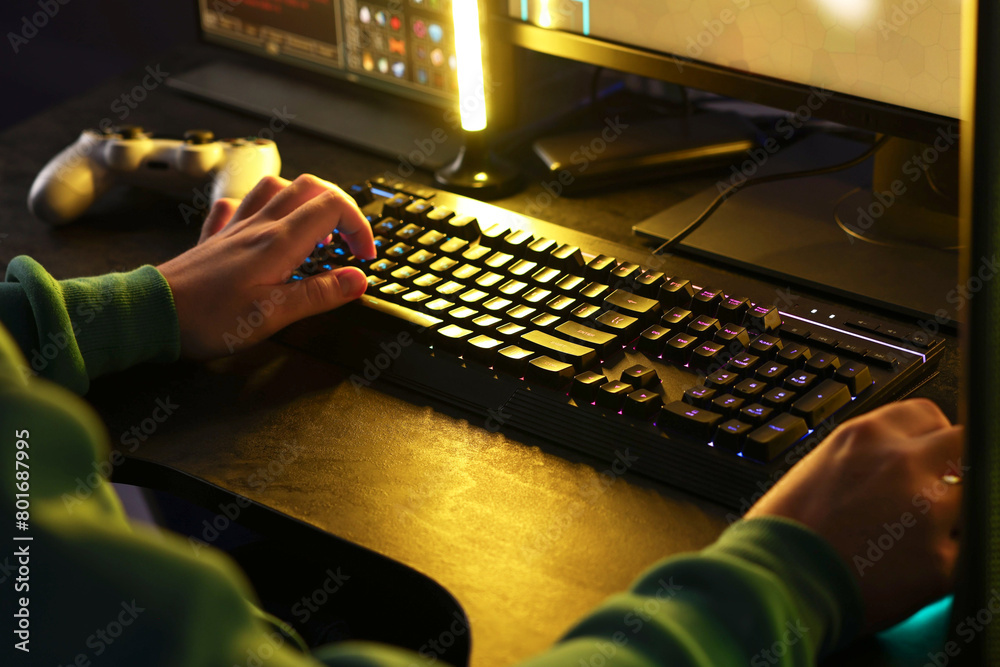 Wall mural man playing video games on computer indoors, closeup