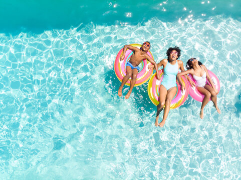 Diverse family enjoy a pool day, with copy space