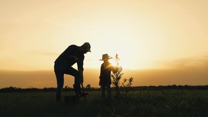 boy son child father tree shovel plant farmer gardener field garden silhouette sunset family...