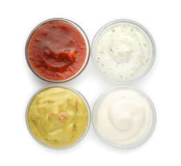 Many different sauces in bowls on white background, top view