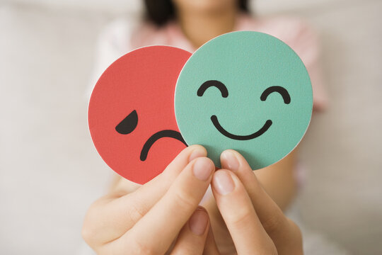 Preteen tween hands holding sad face hiding behind happy face, anxiety mental health, autism psychology, introvert mood change concept