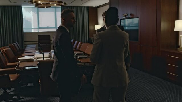 Back tracking footage of two diverse lawyers arriving at conference hall to have meeting with legal aid agency manager about legal issuesBack tracking footage of two diverse lawyers arriving at confer