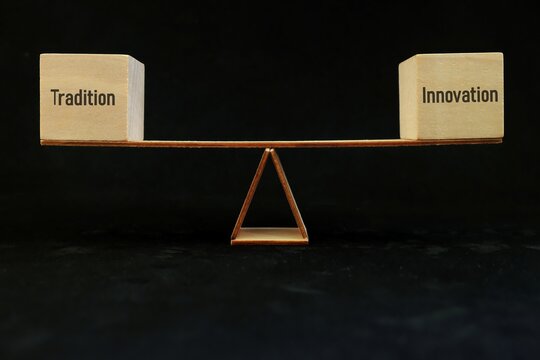 Balance tradition and innovation concept. Wooden blocks on a scale.