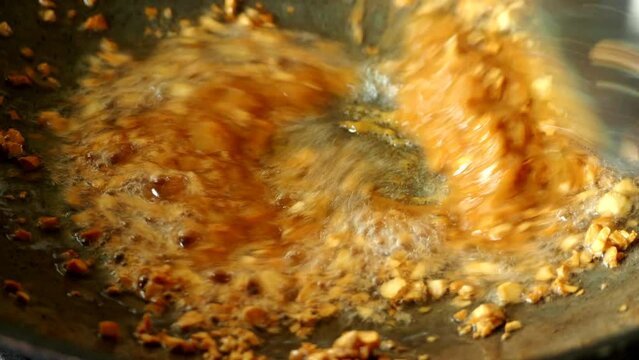 Frying bean paste with garlic in pan, in door  Chiangmai  Thailand.