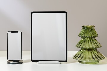 Christmas tablet and phone blank screen, vase, winter festive home decor