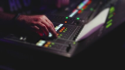 View of lighting technician operator working on mixing console workplace during live event concert on stage show broadcast, light mixer controller panel, sound technician with professional equipment
