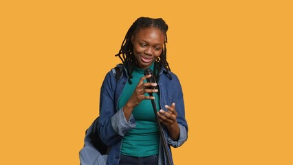 African american motivational speaker talking in microphone, addressing audience, holding speech, studio background. Inspiring woman using mic to present life lectures, camera A