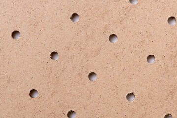 Brown background, wooden texture with holes