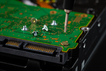 Hard disk drive and printed circuit board with SATA power connector. Magnetic driver torx bit and small machine screw