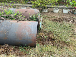 old metal tube in the garden in the yard