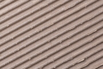 Corrugated paper texture, brown background