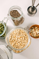 Oatmeal, chia and pumpkin seeds in a glass jars, healthy nutrition ingredients