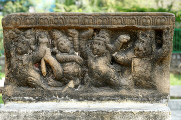 Bas relief sculptures of ancient dwarfs in Sandstone panel at historical Kanchi Kailasanathar temple garden in Kanchipuram, Tamil Nadu.