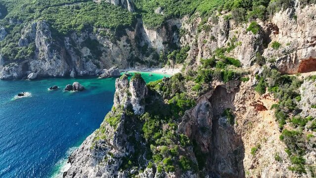 Giali beach in corfu, greece with turquoise waters and rugged cliffs, aerial view