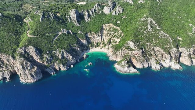 Giali beach on corfu island with turquoise waters and rugged cliffs, sunny day, aerial view