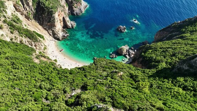 Giali beach in corfu with turquoise waters surrounded by greenery and cliffs, aerial view