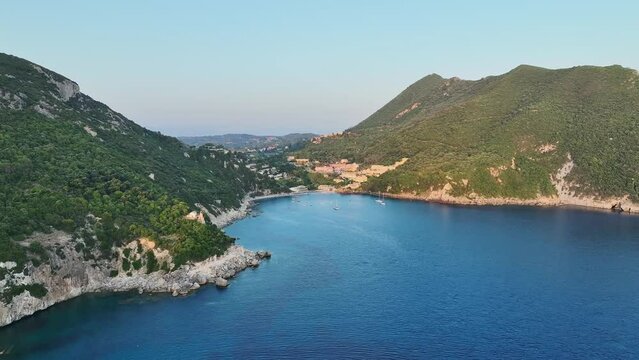 Ermones beach on corfu island, golden hour sunlight kissing the ionian sea, aerial view