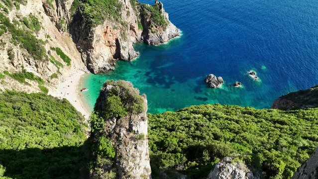 Giali beach on corfu island, turquoise waters surrounded by lush cliffs, aerial view
