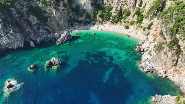 Giali beach in corfu, greece with crystal-clear blue waters and rugged cliffs, aerial view