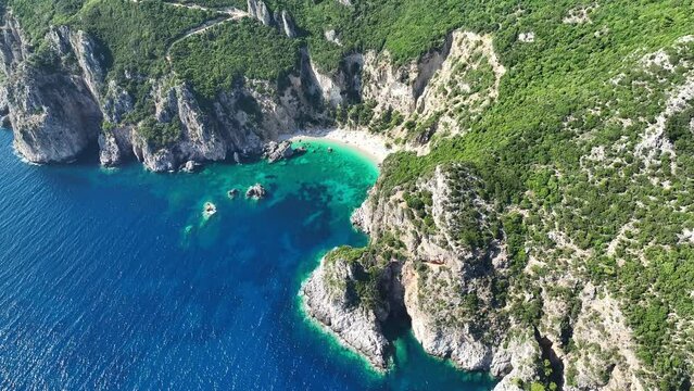 Giali beach on corfu island with turquoise waters and rugged cliffs, sunny day, aerial view