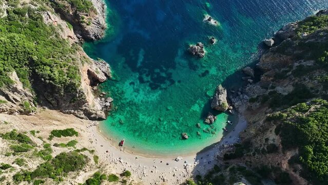 Giali beach in corfu with clear blue waters and sandy shore, greece, aerial view