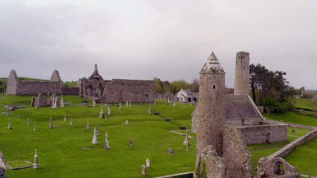 Captivating aerial of Clonmacnoise on a windy day, focusing on round tower.