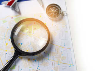 Travel compass and magnifying glass. ,identifying a destination and looking for a secure path