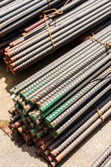 Detailed image showing bundles of reinforced steel bars, tied together, ready for use in building and construction projects. Delivered at the port.