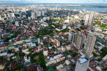 Cebu CIty, Philippines - May 19, 2022: This image showcases Cebu City's skyline with a mix of tall skyscrapers and dense residential areas, emphasizing the city's growth and urban density.