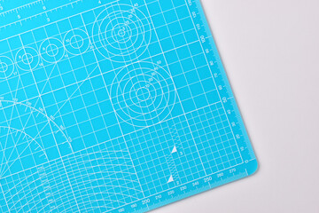 blue cutting mat board on white background with line and scale measure guide pattern for object art...