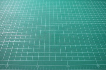 green cutting mat board background with line and scale measure guide pattern for object art design, tool equipment of diy craft work