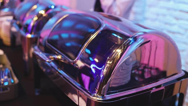 Beautifully decorated catering banquet table with different main course hot food dishes and garnish, with rice, chicken, salmon fish, lamb, vegetables and kebab on party event wedding celebration
