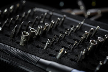 Screwdriver kit, aluminum bit driver on black tray. Driver handle with magnetic bit socket and knurled grip.