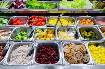 Close up of various vegetables mixed  salad bar in supermarket 