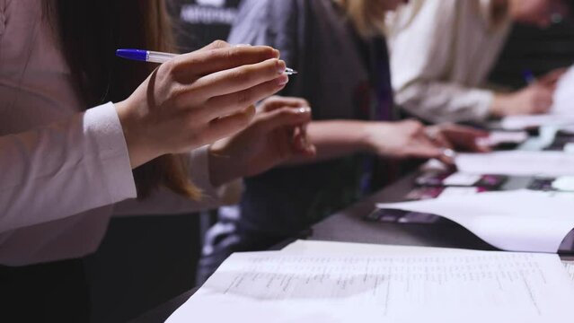 Process of checking in on a conference congress forum event, registration desk table, visitors and attendees receiving a name badge and entrance wristband bracelet and register electronic ticket
