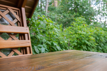 Wooden table at alcove in garden outdoor. Background of greenery. Template mock up podium for advertisement. Connection with nature