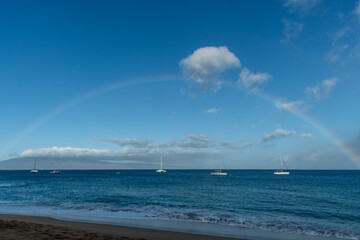 Beautiful complete rainbow at the west shore of Maui at sunrise, Hawaii