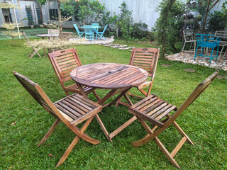 Set of furniture in the garden - wooden table and wooden chairs