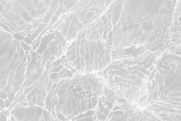 White water with ripples on the surface. Defocus blurred transparent white colored clear calm water surface texture with splashes and bubbles. Water waves with shining pattern texture background.