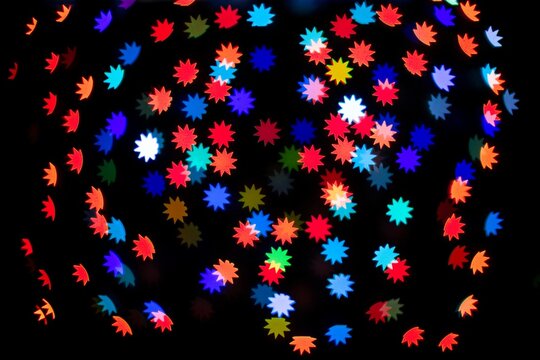 Colorful glitter polygon star bokeh sequin confetti on black background
